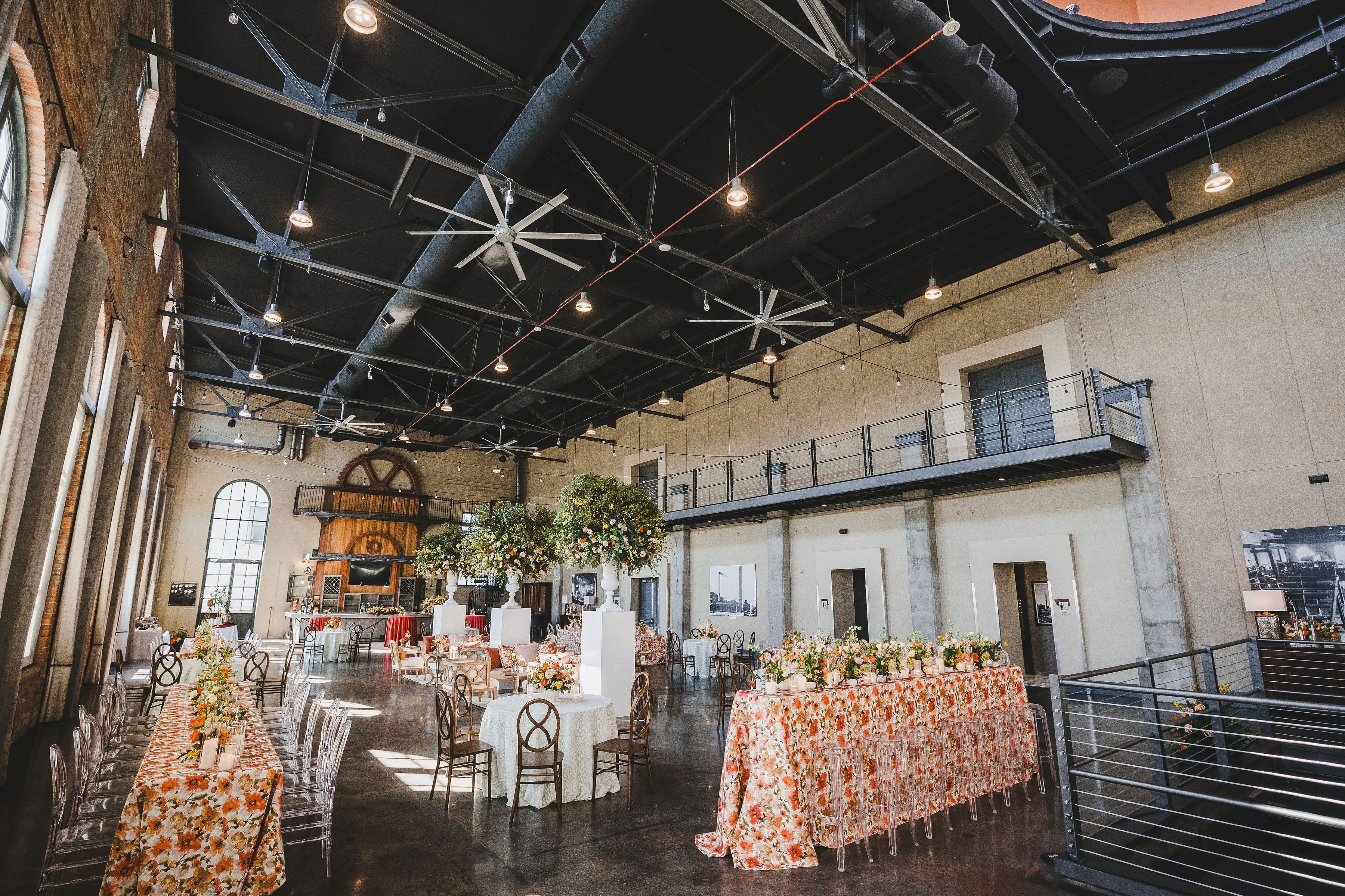 wedding reception tables with colorful floral linens