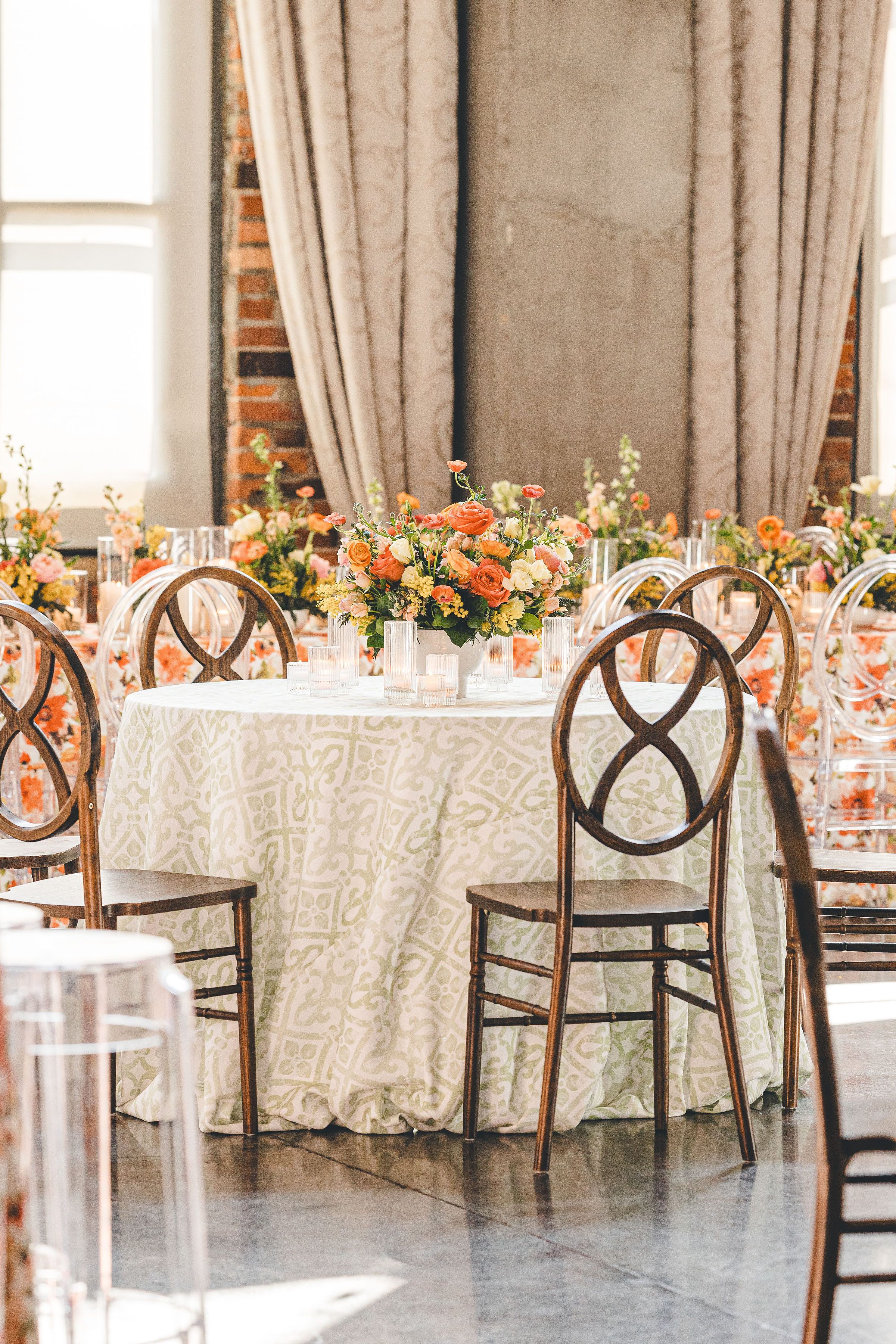 wedding reception table with colorful floral centerpiece