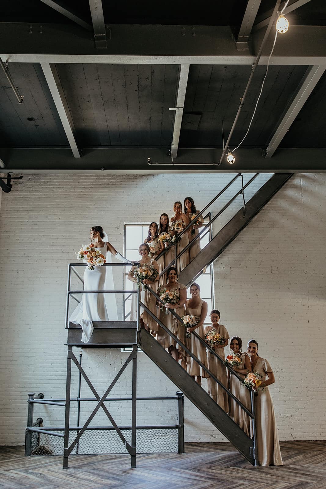 bride with bridesmaids standing on stairwell