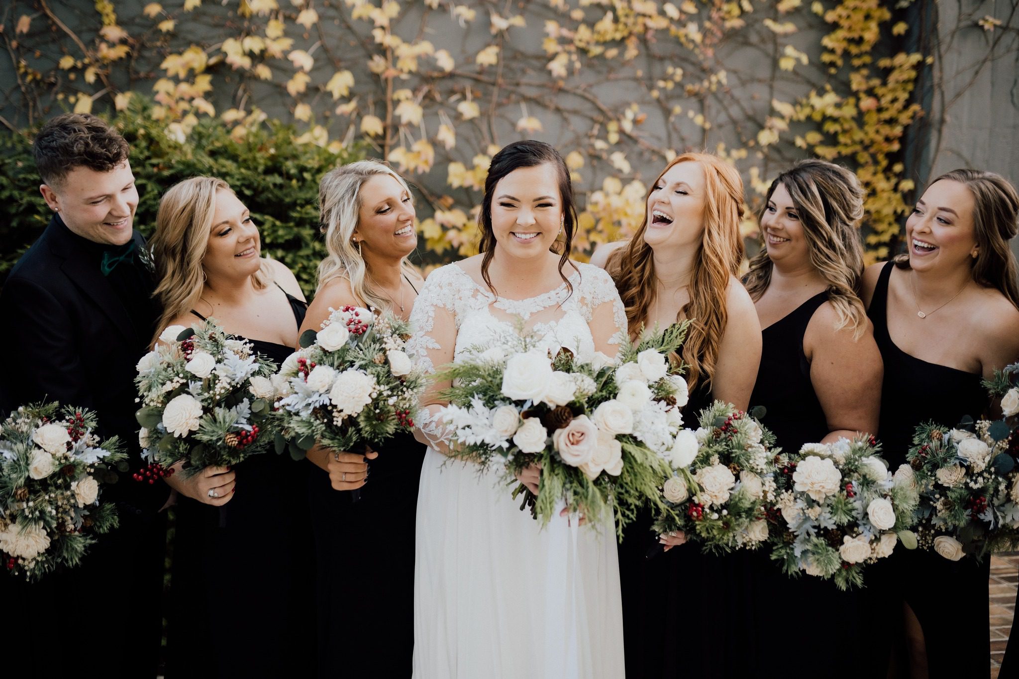 bride with bridesmaids in black gowns