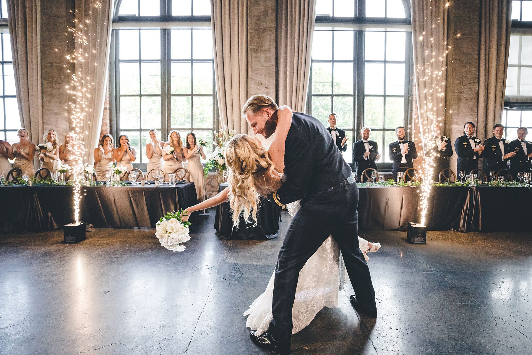 bride and groom dancing with sparklers in background
