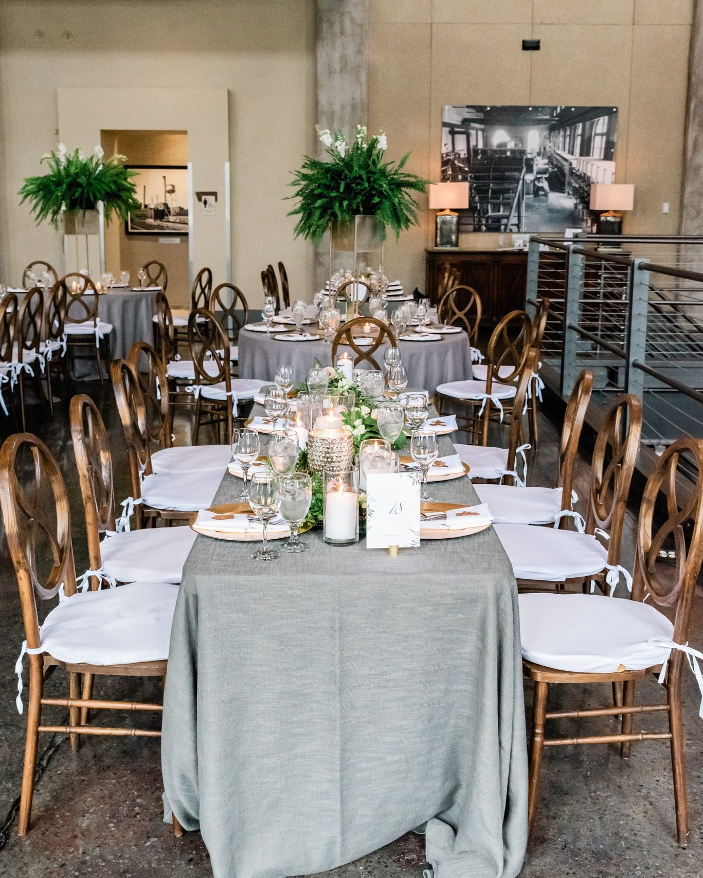 wedding reception table with wooden chairs