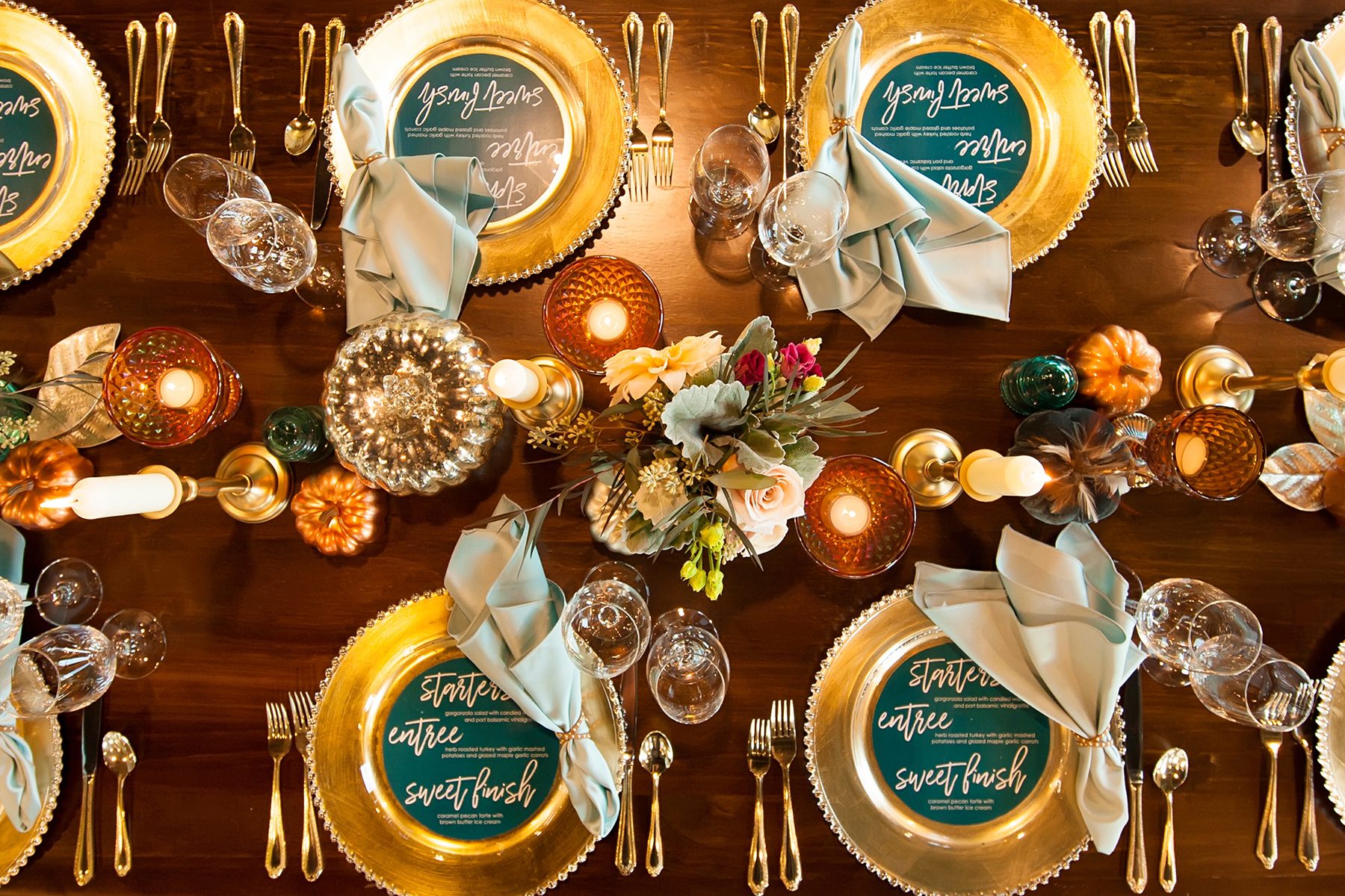 gold and green fall themed wedding reception place settings