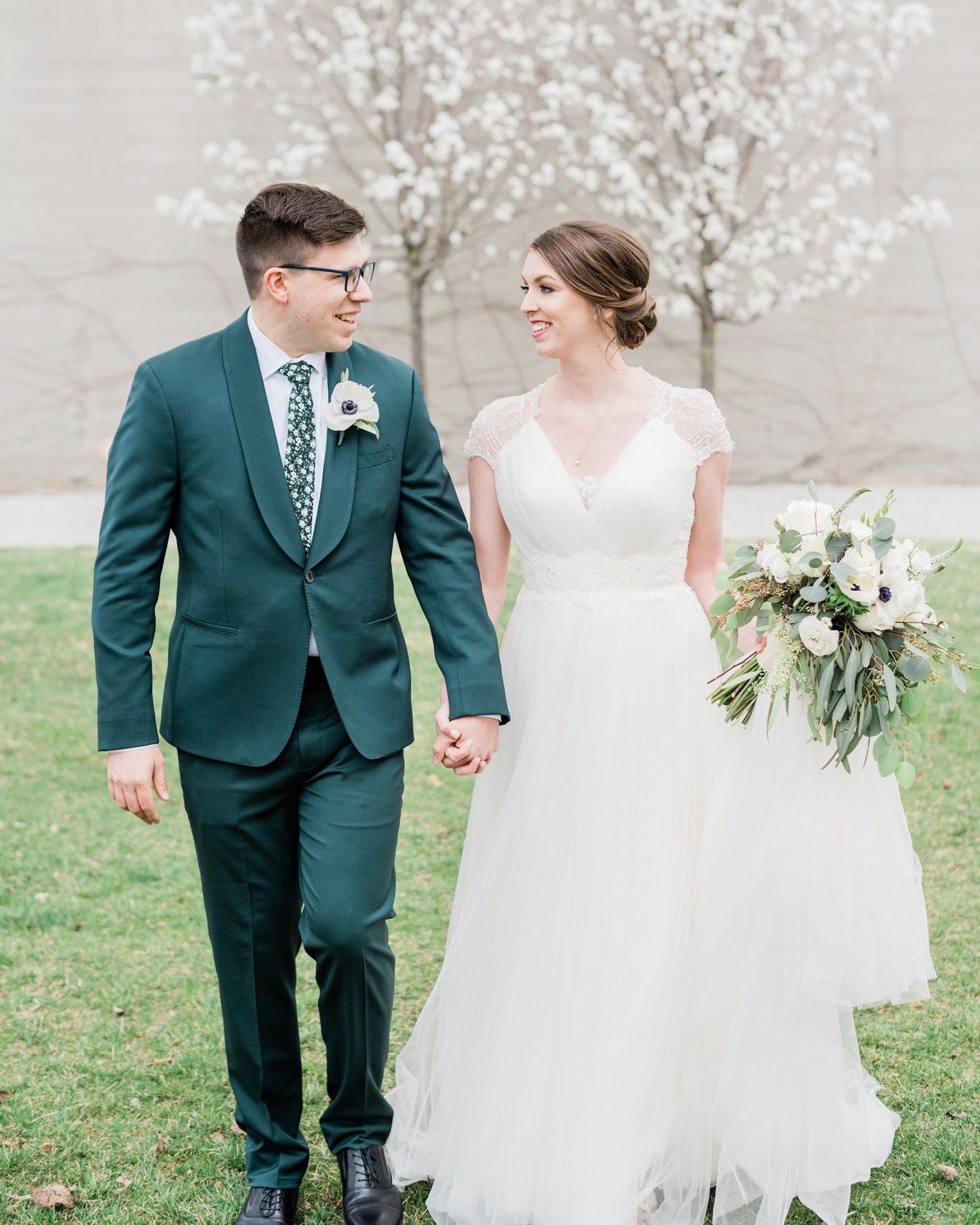 bride and groom holding hands