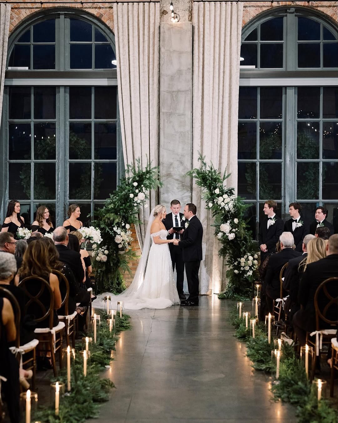 indoor wedding ceremony with candle aisle runner