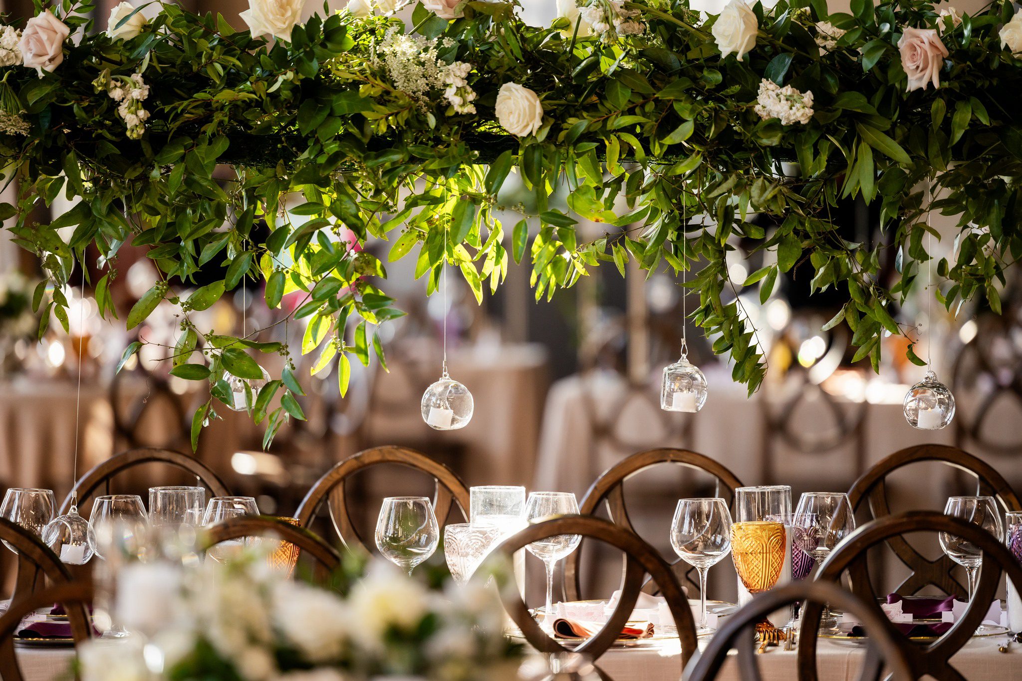large wedding floral arrangement with hanging candles