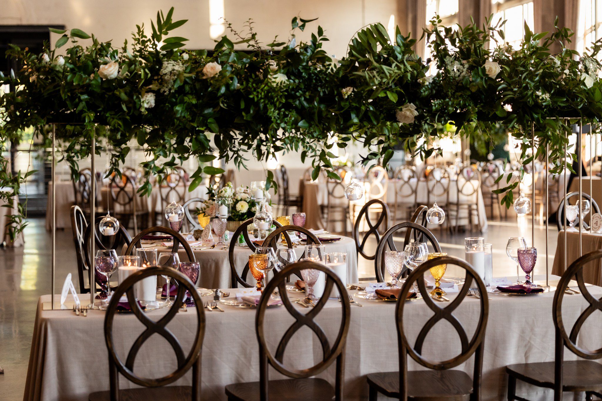 wedding reception table with elevated floral arrangement