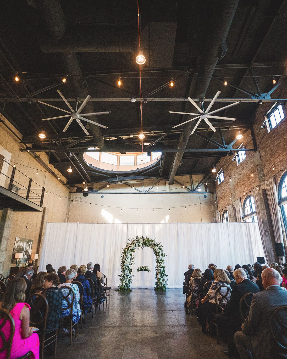 wedding ceremony venue with tall ceilings and exposed brick