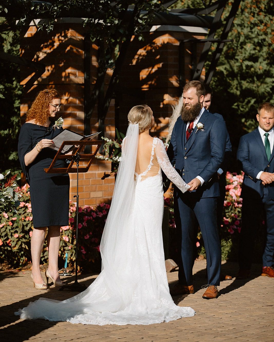 bride and groom holding hands while saying vows