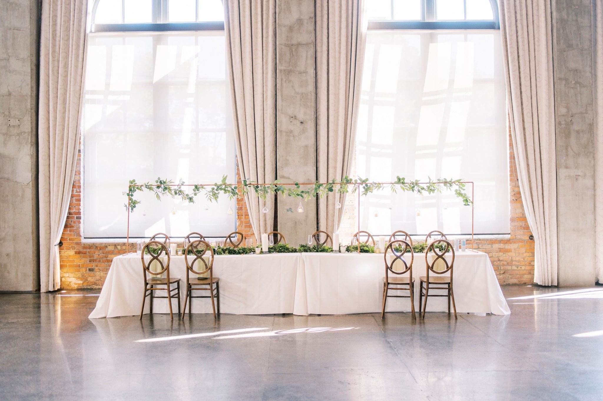wedding party table in front of large windows