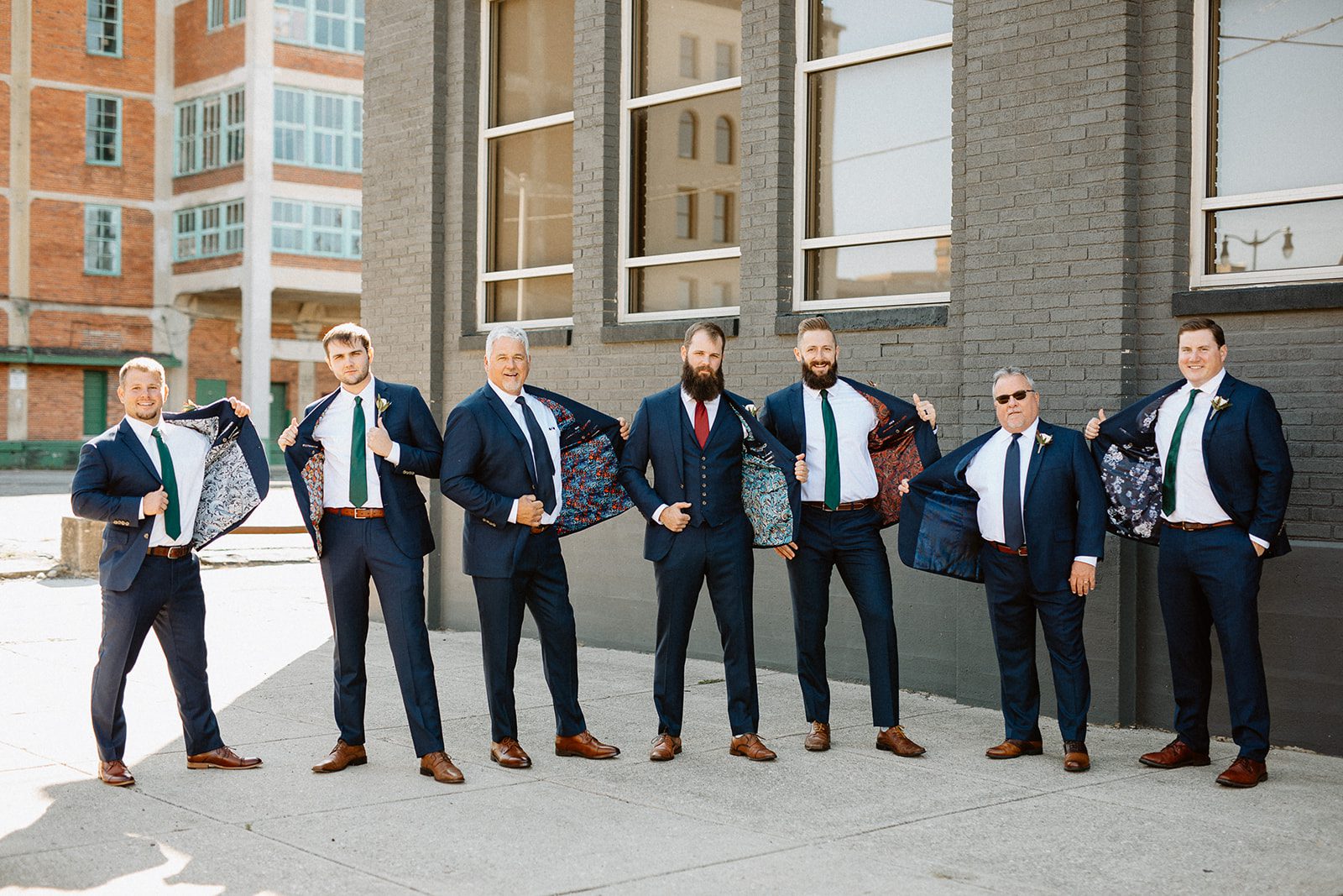 groomsmen showing off colorful coat linings